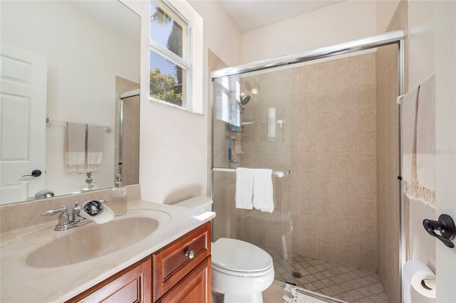 full bath featuring toilet, vanity, and a shower stall
