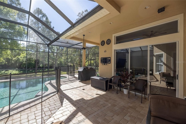 view of patio / terrace with glass enclosure, a grill, and an outdoor pool