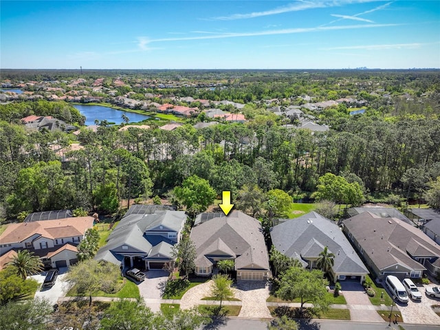 drone / aerial view featuring a residential view and a water view