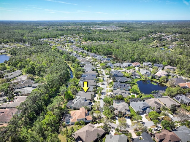 drone / aerial view featuring a residential view and a water view