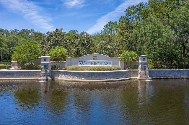 community / neighborhood sign with a water view