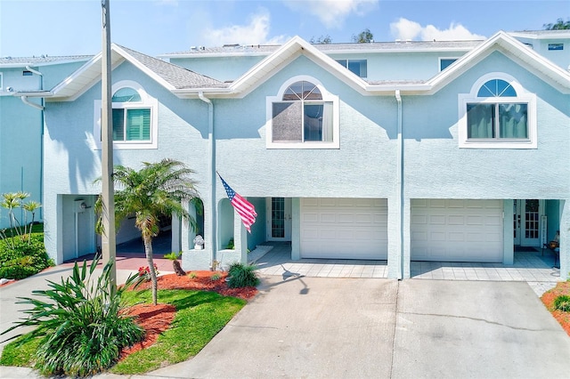 615 Garland Cir, Indian Rocks Beach, FL 33785 - view of property with concrete driveway, an attached garage, and stucco siding