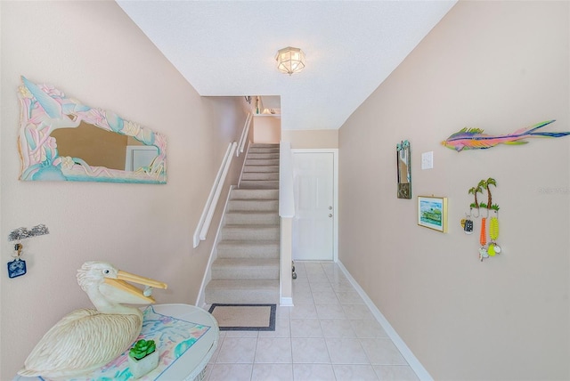 615 Garland Cir, Indian Rocks Beach, FL 33785 - stairway with tile patterned flooring and baseboards