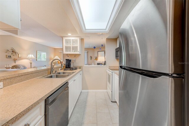 615 Garland Cir, Indian Rocks Beach, FL 33785 - kitchen featuring appliances with stainless steel finishes, a sink, light countertops, and baseboards