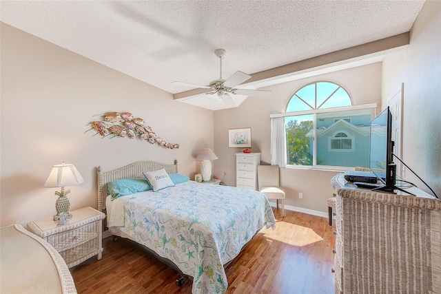 615 Garland Cir, Indian Rocks Beach, FL 33785 - bedroom featuring wood finished floors, baseboards, ceiling fan, and a textured ceiling