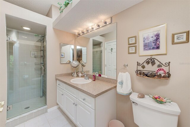 615 Garland Cir, Indian Rocks Beach, FL 33785 - bathroom with toilet, vanity, a shower stall, tile patterned flooring, and a textured ceiling