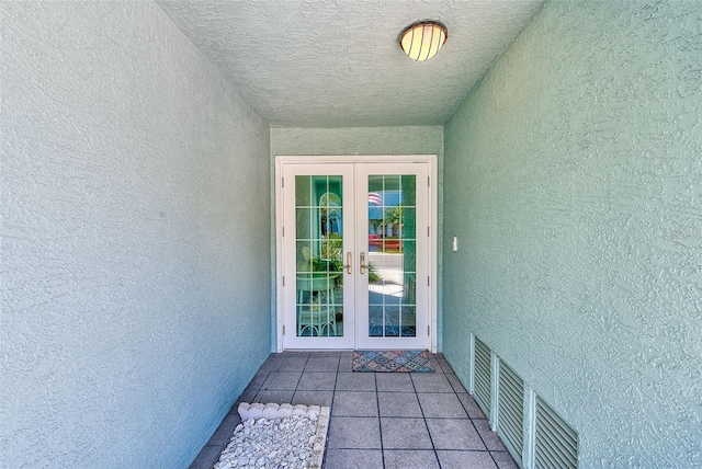 615 Garland Cir, Indian Rocks Beach, FL 33785 - view of exterior entry with french doors and stucco siding