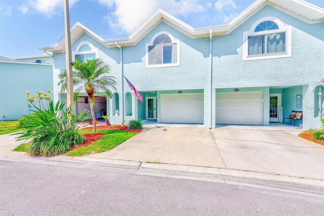 615 Garland Cir, Indian Rocks Beach, FL 33785 - view of property featuring driveway, an attached garage, and stucco siding