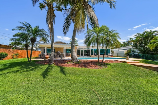 6667 28th St S, Saint Petersburg, FL 33712 - back of house featuring fence private yard, a lawn, a patio area, and a fenced in pool