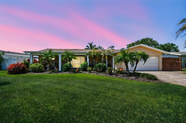 6667 28th St S, Saint Petersburg, FL 33712 - single story home with concrete driveway, an attached garage, fence, and a front lawn