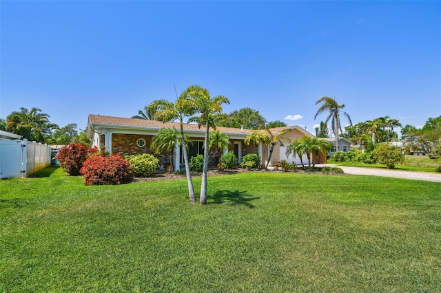 6667 28th St S, Saint Petersburg, FL 33712 - ranch-style home featuring fence, an attached garage, driveway, and a front yard
