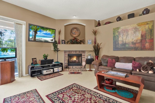living area with carpet flooring, a brick fireplace, and a textured ceiling