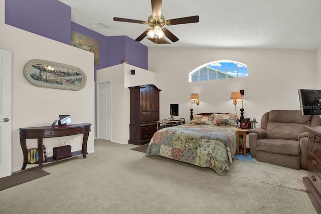 carpeted bedroom with a textured ceiling, lofted ceiling, and a ceiling fan