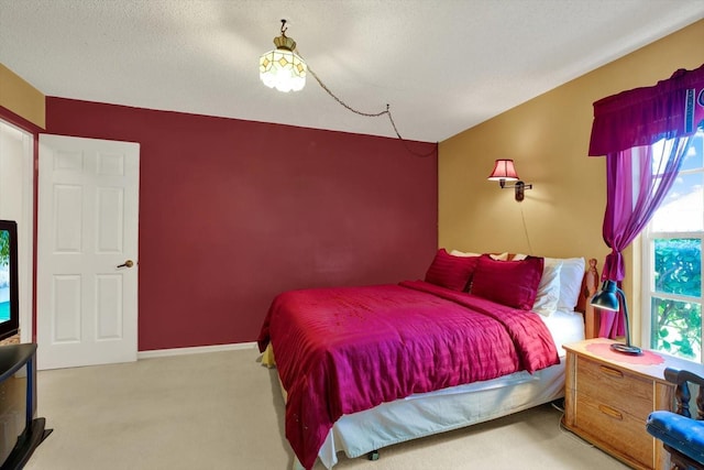 carpeted bedroom featuring baseboards, multiple windows, and a textured ceiling