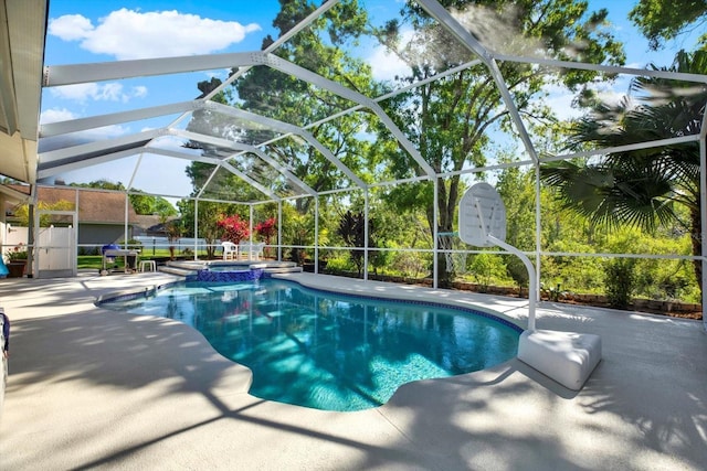 view of pool featuring a pool with connected hot tub, a lanai, and a patio area