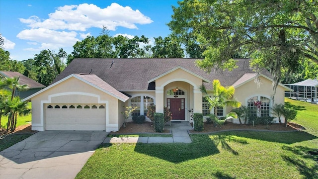 view of front of property featuring stucco siding, driveway, a garage, and a front yard