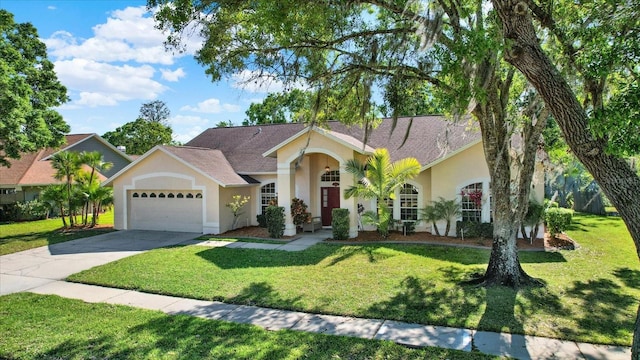 view of front facade featuring stucco siding, driveway, a garage, and a front lawn