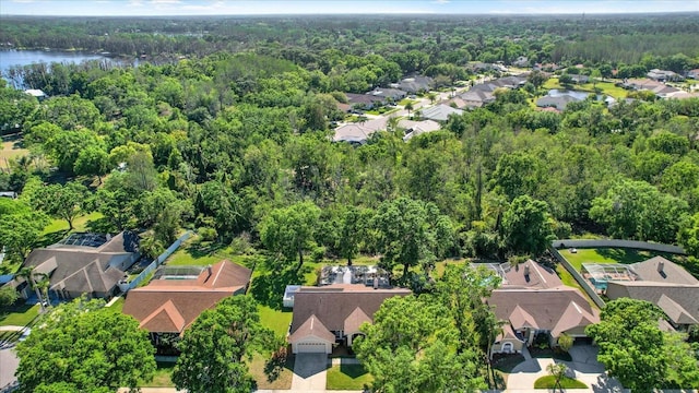 aerial view featuring a residential view, a water view, and a forest view