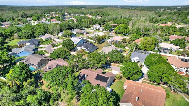 birds eye view of property featuring a forest view and a residential view