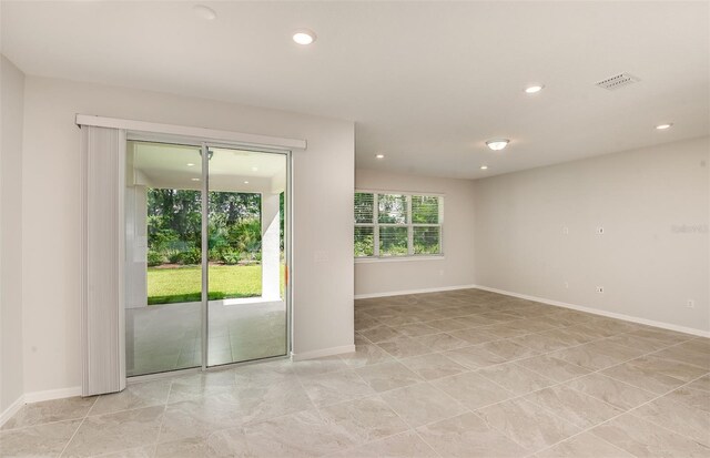 empty room featuring recessed lighting, baseboards, visible vents, and light tile patterned flooring
