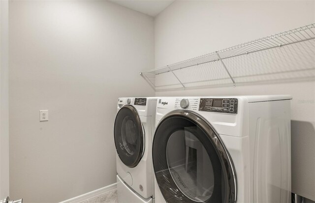 washroom with independent washer and dryer, laundry area, and baseboards