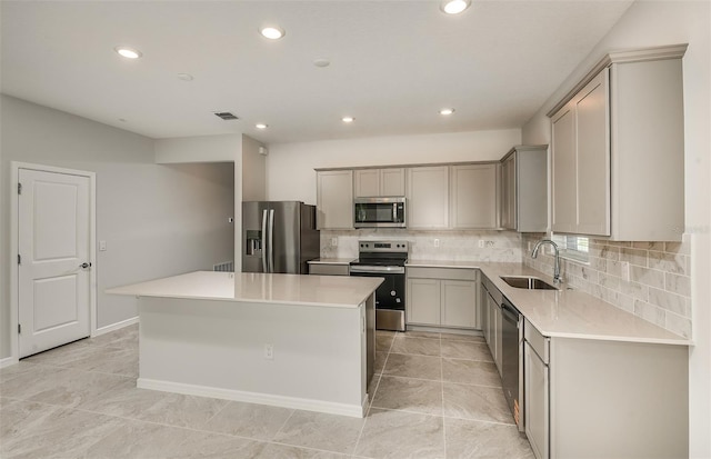 8249 SW 52nd Lane Rd, Ocala, FL 34481 - kitchen with appliances with stainless steel finishes, a sink, gray cabinetry, a kitchen island, and recessed lighting