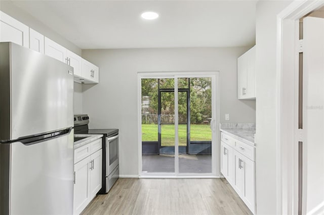 7711 Amherst St Unit A & B, Tampa, FL 33625 - kitchen featuring appliances with stainless steel finishes, light wood-style floors, recessed lighting, white cabinets, and baseboards