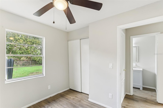 7711 Amherst St Unit A & B, Tampa, FL 33625 - unfurnished bedroom featuring light wood-style flooring, a closet, baseboards, and ceiling fan