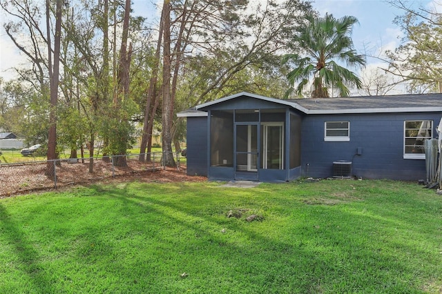 7711 Amherst St Unit A & B, Tampa, FL 33625 - rear view of property with a sunroom, central AC unit, and concrete block siding