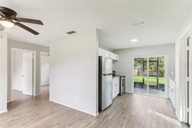 7711 Amherst St Unit A & B, Tampa, FL 33625 - kitchen featuring appliances with stainless steel finishes, ceiling fan, white cabinetry, light wood finished floors, and baseboards