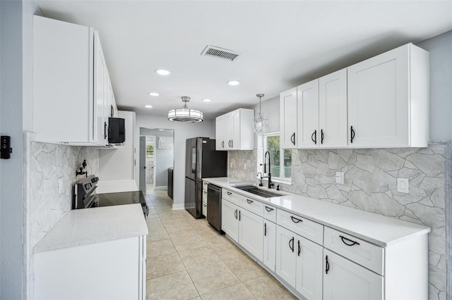 1832 Flamingo Dr, North Fort Myers, FL 33917 - kitchen with a sink, black appliances, visible vents, and a healthy amount of sunlight