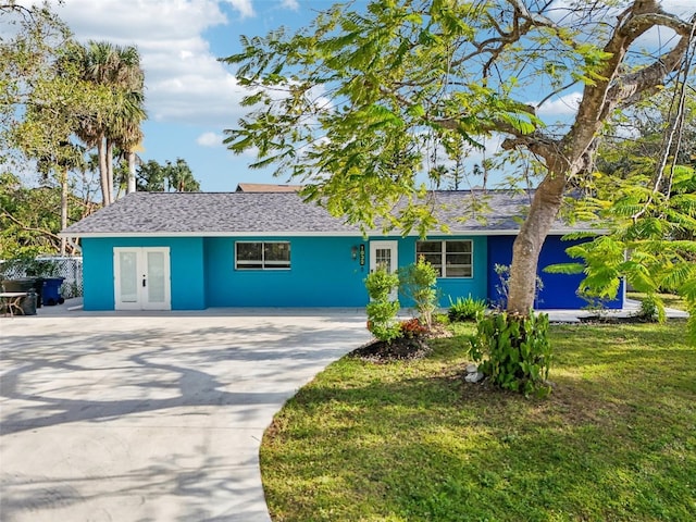 1832 Flamingo Dr, North Fort Myers, FL 33917 - single story home featuring french doors, a front lawn, and concrete driveway
