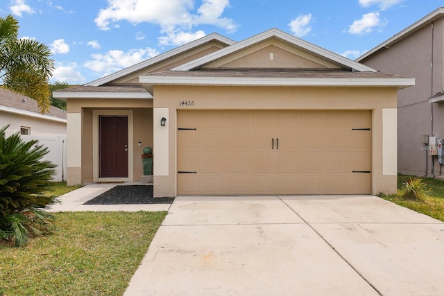 14426 Haddon Mist Dr, Wimauma, FL 33598 - single story home with stucco siding, an attached garage, fence, and driveway