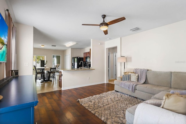 14426 Haddon Mist Dr, Wimauma, FL 33598 - living area featuring a ceiling fan, dark wood-type flooring, baseboards, and visible vents