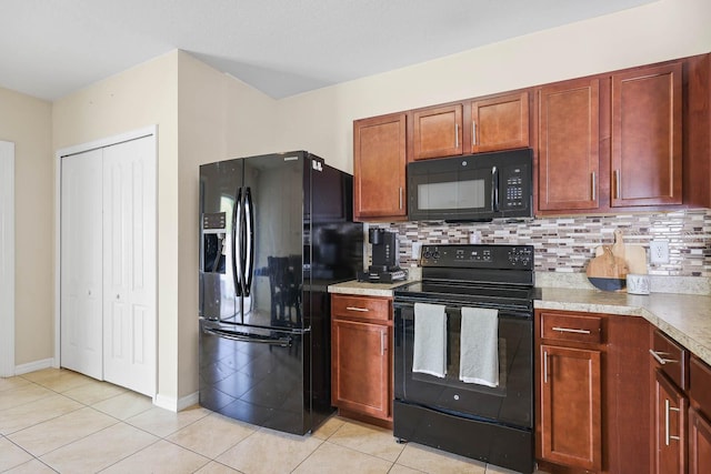 14426 Haddon Mist Dr, Wimauma, FL 33598 - kitchen with decorative backsplash, light countertops, black appliances, and light tile patterned floors