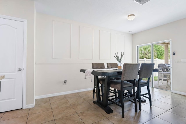 14426 Haddon Mist Dr, Wimauma, FL 33598 - dining space with baseboards and light tile patterned floors
