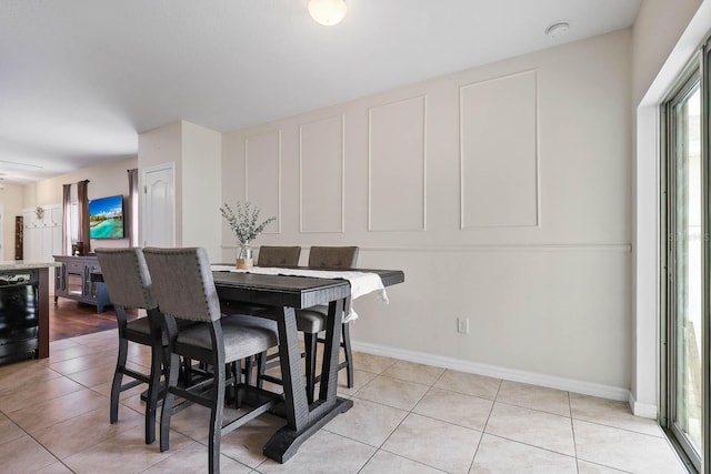 14426 Haddon Mist Dr, Wimauma, FL 33598 - dining area with light tile patterned flooring, baseboards, and wine cooler
