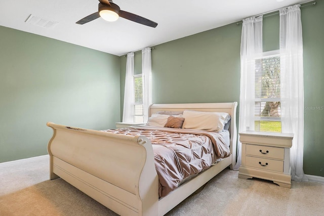 14426 Haddon Mist Dr, Wimauma, FL 33598 - bedroom with light carpet, baseboards, visible vents, and ceiling fan