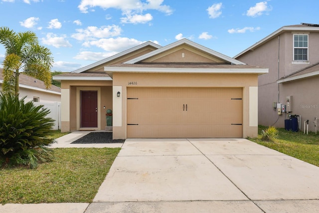 14426 Haddon Mist Dr, Wimauma, FL 33598 - view of front of property with driveway, stucco siding, and a garage
