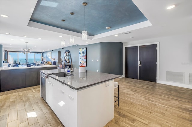 19816 Gulf Blvd Unit 201, Indian Shores, FL 33785 - kitchen featuring a tray ceiling, modern cabinets, visible vents, a sink, and open floor plan