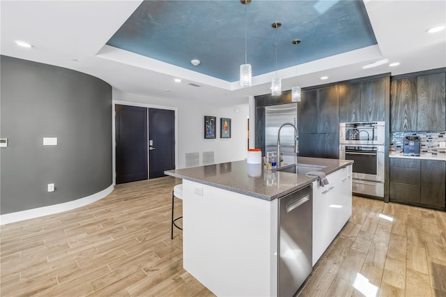 19816 Gulf Blvd Unit 201, Indian Shores, FL 33785 - kitchen with appliances with stainless steel finishes, modern cabinets, a raised ceiling, and a sink