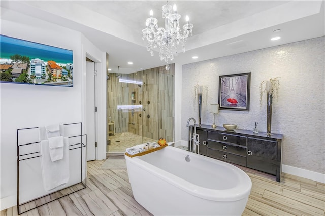 19816 Gulf Blvd Unit 201, Indian Shores, FL 33785 - bathroom with recessed lighting, a chandelier, a stall shower, and a freestanding tub
