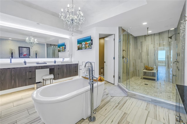 19816 Gulf Blvd Unit 201, Indian Shores, FL 33785 - full bath with an inviting chandelier, double vanity, a stall shower, a sink, and a soaking tub