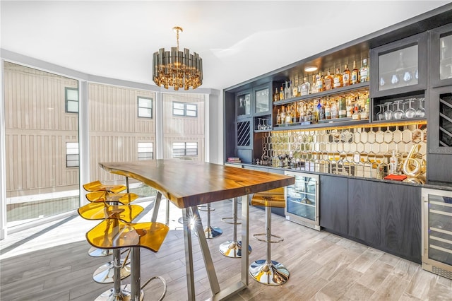 19816 Gulf Blvd Unit 201, Indian Shores, FL 33785 - bar featuring wine cooler, wet bar, and light wood-style floors