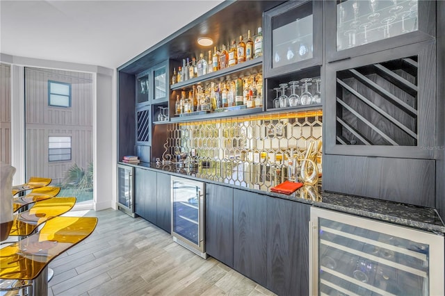 19816 Gulf Blvd Unit 201, Indian Shores, FL 33785 - bar with beverage cooler, a dry bar, and light wood-style floors