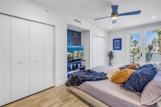 19816 Gulf Blvd Unit 201, Indian Shores, FL 33785 - bedroom with access to exterior, two closets, visible vents, ceiling fan, and light wood-style floors