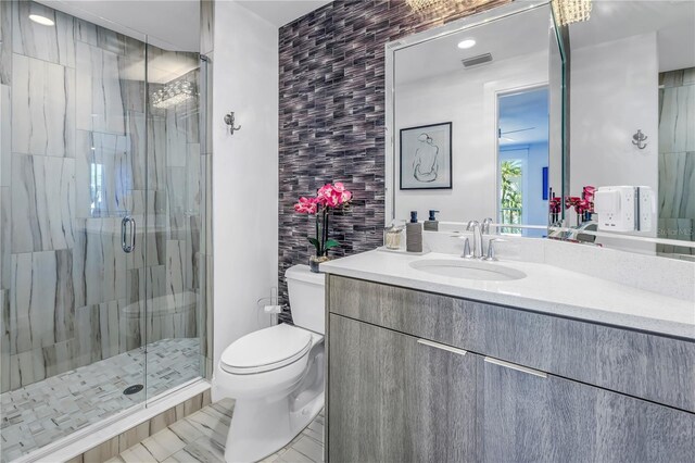 19816 Gulf Blvd Unit 201, Indian Shores, FL 33785 - bathroom with vanity, toilet, a shower stall, and visible vents