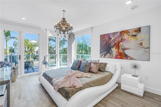 19816 Gulf Blvd Unit 201, Indian Shores, FL 33785 - bedroom with light wood finished floors, access to outside, baseboards, a chandelier, and recessed lighting