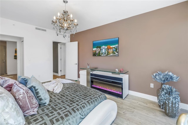 19816 Gulf Blvd Unit 201, Indian Shores, FL 33785 - bedroom featuring baseboards, light wood-style floors, a chandelier, and visible vents