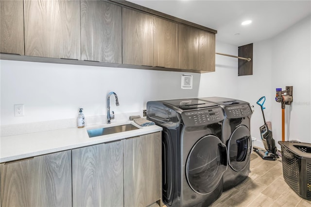 19816 Gulf Blvd Unit 201, Indian Shores, FL 33785 - laundry area with a sink, separate washer and dryer, light wood-type flooring, and cabinet space